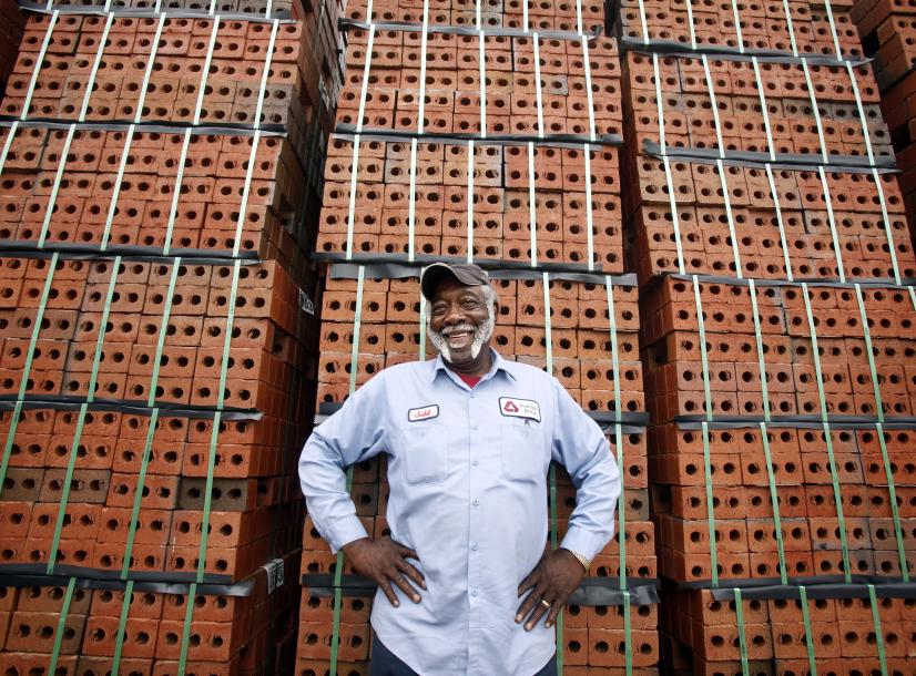 Man standing in front of pallets of brick